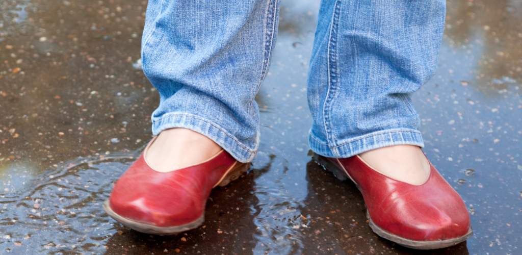 pair of red leather shoes in the rain