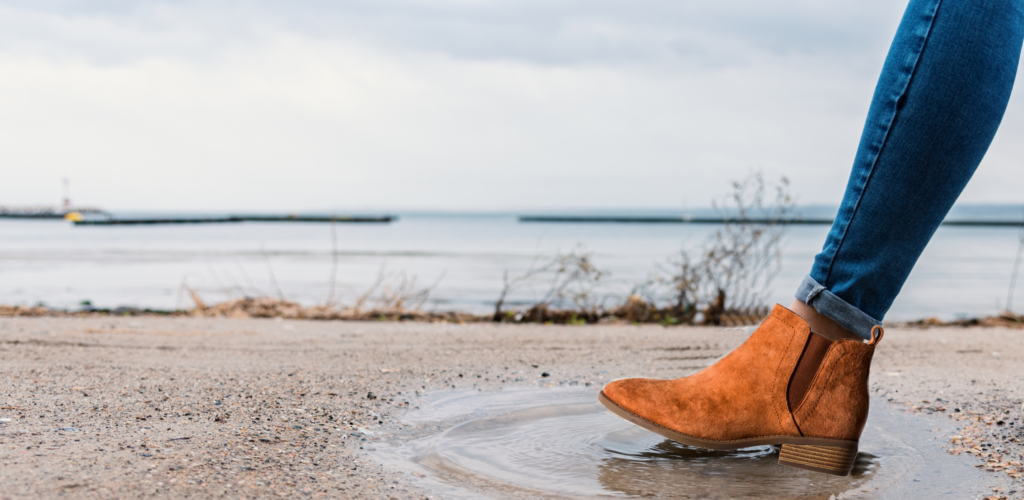 women in suede boot almost getting them wet