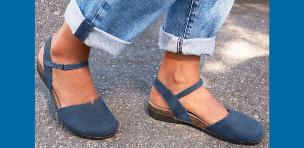 Navy blue Dansko Rowan with pair of cuffed jeans