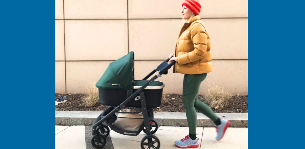 Modern mom pushing stroller in the Hoka Arahi