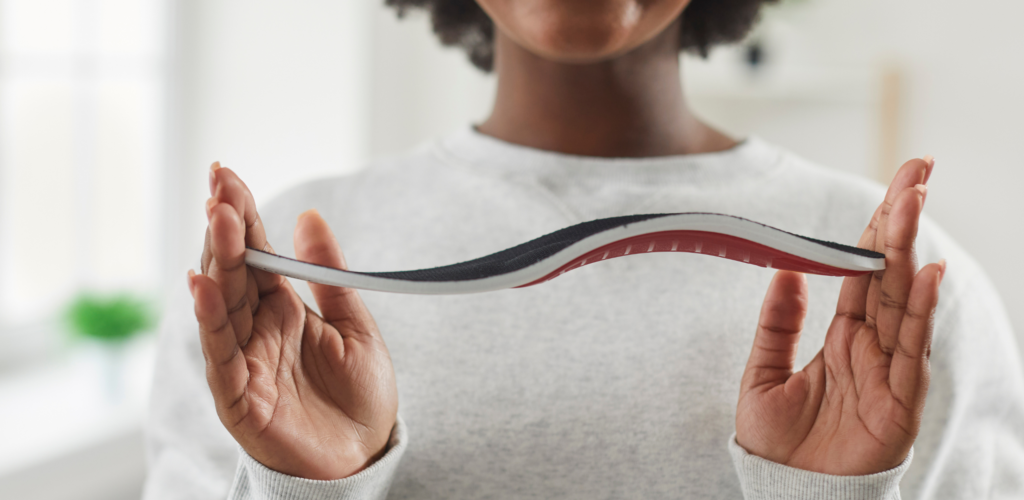 woman holding contoured insole with arch support